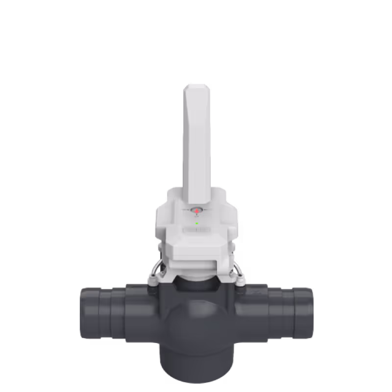 White control valve mounted on black pipe fitting for irrigation water flow management.